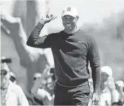  ?? MIKE EHRMANN/GETTY IMAGES ?? Tiger Woods reacts to his birdie putt on the 7th hole on Thursday at Bay Hill. Woods seemed to be enjoying himself and the fans were right there with him. “They’re into it,” Woods said.