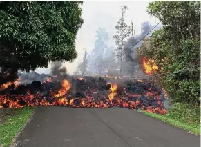  ?? — AFP ?? Fiery: Lava flow moving on Makamae Street in Leilani Estates.