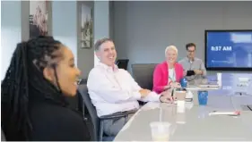  ?? CONTRIBUTE­D PHOTO BY UNUM ?? Unum President and CEO Rick McKenney talks with a group of employees at the insurer’s offices.