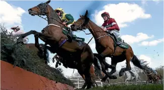  ?? PHOTO: GETTY IMAGES ?? Milansbar jumps Canal Turn ahead of eventual race winner Tiger Rol, ridden by Davey Russell, in the Grand National Steeplecha­se at Aintree in Liverpool.