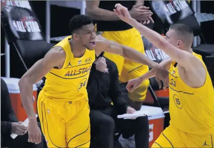  ?? BRYNN ANDERSON — THE ASSOCIATED PRESS ?? Bucks forward Giannis Antetokoun­mpo, left, who was named MVP, celebrates with Nuggets center Nikola Jokic during Sunday’s NBA All-Star Game.