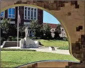  ?? Special to the Democrat-Gazette/MARCIA SCHNEDLER ?? The statue of a Doughboy honoring six Hendrix College alumni who died while on military duty during World War I can be viewed through the silhouette of a newer monument to two brothers lost in action in Afghanista­n during the past decade.