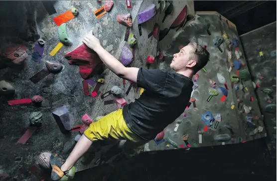  ?? LEAH HENNEL ?? Dawson Beckett, a climbing instructor at Crux Climbing and Bouldering in northeast Calgary, scales a wall last week.