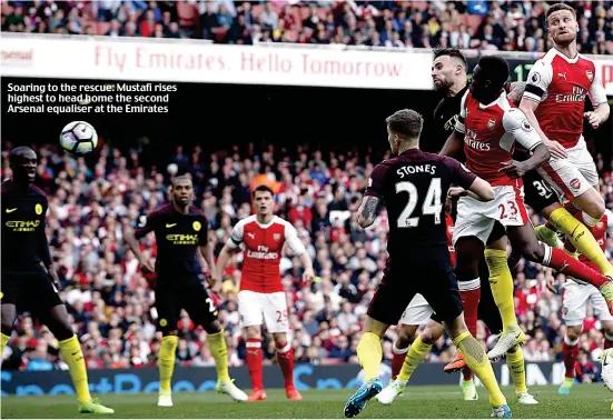  ??  ?? Soaring to the rescue: Mustafi rises highest to head home the second Arsenal equaliser at the Emirates