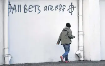  ?? REUTERS ?? Loyalist graffitis are seen with messages against the Brexit border checks in relation to the Northern Ireland protocol at the harbour in Larne, Northern Ireland, on Feb. 12.