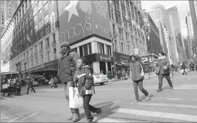  ?? MARK LENNIHAN / AP ?? Macy's shoppers leave