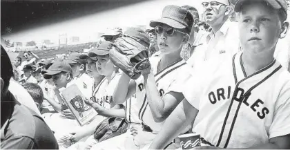  ?? BALTIMORE SUN FILE ?? Young Orioles fans cheer on their team while attending a game at Memorial Stadium in August 1954. The Orioles ended the year with a disappoint­ing record of 54 wins and 100 losses, but fans were still excited to have profession­al baseball in town.