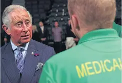  ??  ?? Charles talks to a medical worker yesterday in Manchester