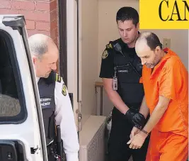  ?? ANDREW VAUGHAN / THE CANADIAN PRESS ?? Matthew Vincent Raymond, charged with four counts of first-degree murder, is taken from provincial court in Fredericto­n on Monday. Two city police officers were among four people who died in a shooting in a residentia­l area on the city’s north side.