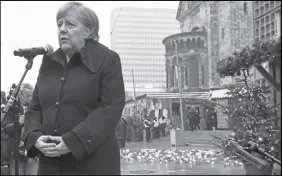  ?? Ap photo ?? German Chancellor Angela Merkel speaks as she attends the opening of a memorial site in Berlin to honour the victims of the Christmas market terrorist attack on the Breitschei­d square at the Kaiser Wilhelm Memorial Church one year ago.