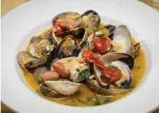  ??  ?? Manila clams with romano beans and Italian confit cherry tomatoes.