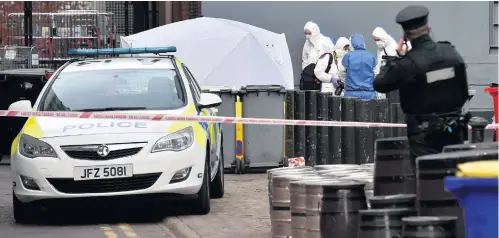  ?? PRESSEYE ?? Police and forensic officers at the scene where the body of a man was found in the Keylands Place area of Belfast yesterday