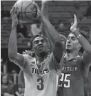  ?? JOEL AUERBACH, AP ?? Texas Tech guard Davide Moretti (25) defends against Memphis guard Jeremiah Martin (3) during the second half of an NCAA college basketball game at the Air Force Reserve Hoophall Miami Invitation­al in Miami on Saturday