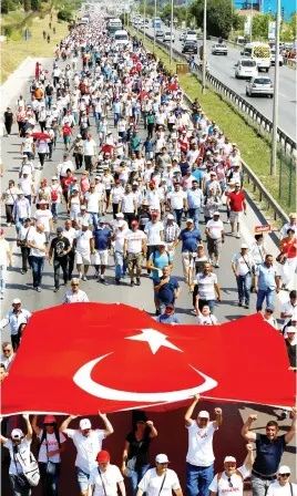  ??  ?? Supporters of Turkey's main opposition Republican People’s Party (CHP) walk during the 23rd day of a protest, dubbed the ‘justice march,’ against the detention of the party’s lawmaker Enis Berberoglu, near Tuzla in Istanbul province, on Friday. (Reuters)