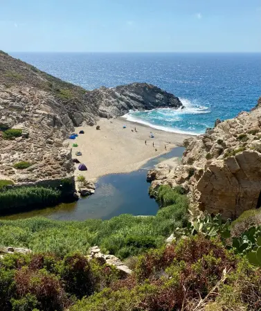  ?? ?? From left: A sandy bay with tents, on Ikaria; Episkopi church in Chora, the capital of Skyros; the Folklore and Ethnologic­al Museum of Chora Skyros