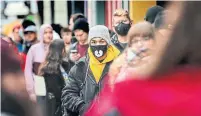  ?? ANDREW FRANCIS WALLACE TORONTO STAR FILE PHOTO ?? Dozens lined up on Yonge Street last March, a week into the lockdown, to buy a new video game from EB Games. Lining up for merchandis­e is a universal pastime, Emma Teitel writes.