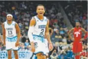  ?? Justin K. Aller, Getty Images ?? Fatts Russell is all smiles after his Rhode Island team beat Oklahoma in overtime in the first round of the NCAA Tournament.