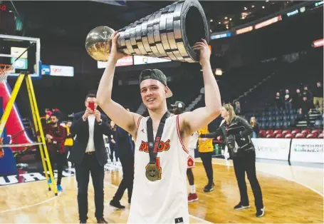  ?? DARREN CALABRESE/THE CANADIAN PRESS FILES ?? University of Calgary Dinos player Andrew Milner, pictured last year with the W.P. McGee trophy, was studying kinesiolog­y and “loved basketball.” RCMP have confirmed the Nova Scotia native was killed in a canoeing accident in Moyie Lake, B.C.