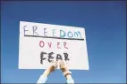  ?? Associated Press ?? A person holds a sign Tuesday while gathering with others to protest stay-at-home orders put into place due to the COVID-19 outbreak outside the Missouri Capitol in Jefferson City.