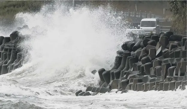  ??  ?? 0 High waves pound the coast of Kagoshima city as Haishen – the second powerful typhoon to slam Japan in a week – unleashed fierce winds