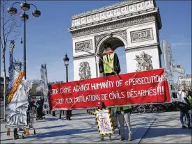  ?? THIBAULT CAMUS / AP ?? Yellow vest protesters gather at the Arc de Triomphe in Paris, Sunday. French yellow vest protesters are marking three months since the kickoff of their anti-government movement.