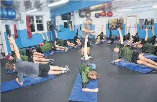  ?? JASON SIMMONDS/JOURNAL PIONEER ?? Kensington Wild fitness coach Brian Arsenault puts the New Brunswick/P.E.I. Major Midget Hockey League team through an off-ice workout at Kensington Credit Union Centre’s FitPlex recently.