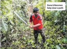  ??  ?? Guna tribesmen help clear a path