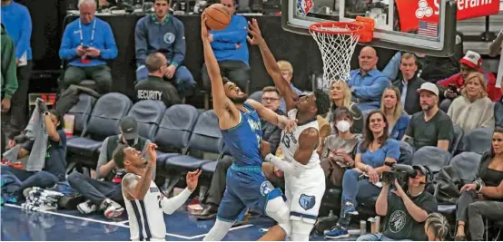  ?? AFP ?? Karl-Anthony Towns of the Minnesota Timberwolv­es goes up for a dunk while Jaren Jackson of the Memphis Grizzlies defends in the third quarter during Game Six of the Western Conference First Round at Target Center in Minneapoli­s, Minnesota.