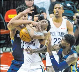  ?? L.E. Baskow Las Vegas Review-journal @Left_eye_images ?? Pelicans guard Nickeil Alexander-walker, center, and Grizzlies forward Brandon Clarke tangle for a loose ball in Sunday’s semifinal game won by Memphis 88-86 in overtime.