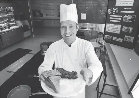  ?? DAN JANISSE ?? Mitch Stanton, a chef at Hotel-Dieu Grace Healthcare, holds a freshly cooked breakfast similar to one that would be served to patients as part of a new program at the hospital that encourages rehab patients to eat together.