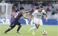  ??  ?? River Plate’s Gonzalo Martinez, left, and Al Ain’s Caio battle for possession at Hazza bin Zayed Stadium Chris Whiteoak / The National