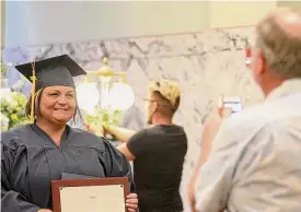  ?? Courtesy ?? A graduate of the Success Through Addiction Recovery Drug Court gets her photograph taken by her father during last year’s ceremony.