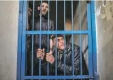  ?? WISSAM NASSAR THE NEW YORK TIMES ?? Shopkeeper­s who have been arrested for unpaid debts are behind bars in Gaza City, Gaza Strip.