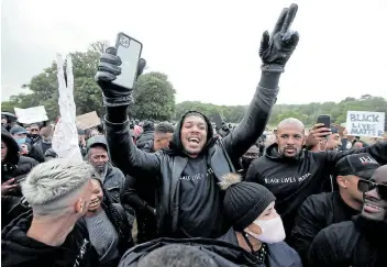  ?? Picture: PAUL CHILDS/REUTERS ?? SPEAKING OUT: Boxer Anthony Joshua is seen with demonstrat­ors during a Black Lives Matter protest in Watford, UK, following the death of George Floyd, who died in police custody in Minneapoli­s last month.