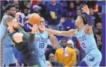  ?? GERALD HERBERT / ASSOCIATED PRESS ?? New Orleans center Jonas Valanciuna­s (17) battles near the basket with Memphis guard Ja Morant (12) during Tuesday’s game in New Orleans,.