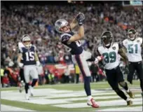  ?? DAVID J. PHILLIP — THE ASSOCIATED PRESS ?? Patriots wide receiver Danny Amendola catches what proved to be the game-winning touchdown in front of Jaguars safety Tashaun Gipson, center, and linebacker Paul Posluszny in the fourth quarter of Sunday’s game.