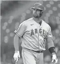  ?? TED S. WARREN/AP ?? The Angels’ Albert Pujols walks to the dugout after he was called out on strikes during the ninth inning against the Mariners on Sunday in Seattle.