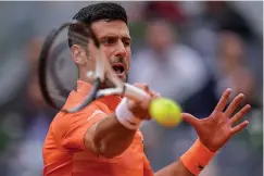  ?? The Associated Press ?? ■ Serbia’s Novak Djokovic returns the ball against Gael Monfils, of France, during their match at the Mutua Madrid Open Tuesday in Madrid, Spain.