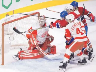  ?? GRAHAM HUGHES/THE CANADIAN PRESS VIA AP ?? Detroit goaltender Jimmy Howard is unable to stop a shot by Montreal’s Tomas Tatar, second from left, during Monday’s game. The Canadiens rolled to a 7-3 victory.