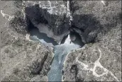  ?? ANDRE PENNER — THE ASSOCIATED PRESS ?? A tourist boat navigates through a canyon in Furnas Lake, near Capitolio City, Brazil.