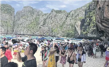  ?? ?? A file photo shows a large number of tourists throng Maya Bay prior to the Covid-19 pandemic.