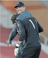  ?? PHIL NOBLE THE ASSOCIATED PRESS ?? Liverpool manager Jurgen Klopp, pictured back, celebrates with goalkeeper Alisson after an English Premier League soccer match against Crystal Palace at Anfield Stadium.