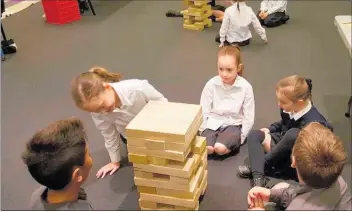  ??  ?? STUDENTS from St Joseph’s Primary school playing Jenga with questions in Ma¯ ori written on the blocks.