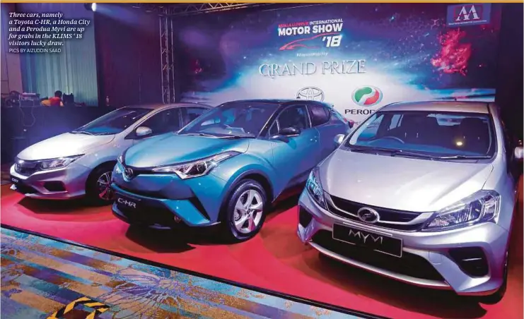  ?? PICS BY AIZUDDIN SAAD ?? Three cars, namely a Toyota C-HR, a Honda City and a Perodua Myvi are up for grabs in the KLIMS ‘ 18 visitors lucky draw.