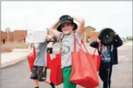  ?? SUBMITTED PHOTO ?? Because the existing East Coventry Elementary School is right next door to the new school, students didn’t have to walk far to carry supplies into their new school on Friday.