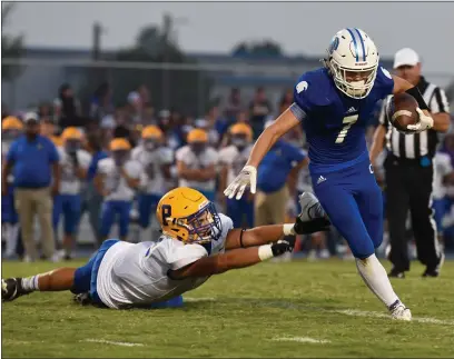  ?? PHOTOS BY MATT BATES – ENTERPRISE-RECORD ?? Orland’s Thomas Schermer escapes the outreached arms of a defender during the Trojans’ season opener against Pierce on Friday.