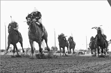  ?? COADY PHOTOGRAPH­Y ?? Iron Fist (second from left) wins the Grade 3 Cornhusker Handicap by two lengths last Saturday.