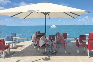  ??  ?? Diners sit at a waterside restaurant in Darwin.