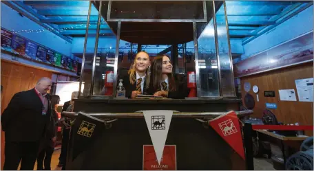  ?? ?? Prestwick Academy pupils Belle Wilson, left and Rosie Wallbanks in the cinema’s original ticket booth Picture: Colin Mearns