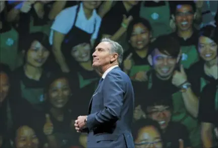  ?? TED S. WARREN — THE ASSOCIATED PRESS FILE ?? Starbucks CEO Howard Schultz walks in front of a photo of Starbucks baristas, at the coffee company’s annual shareholde­rs meeting in Seattle. Starbucks Corp. says Schultz is stepping down executive chairman later this month.